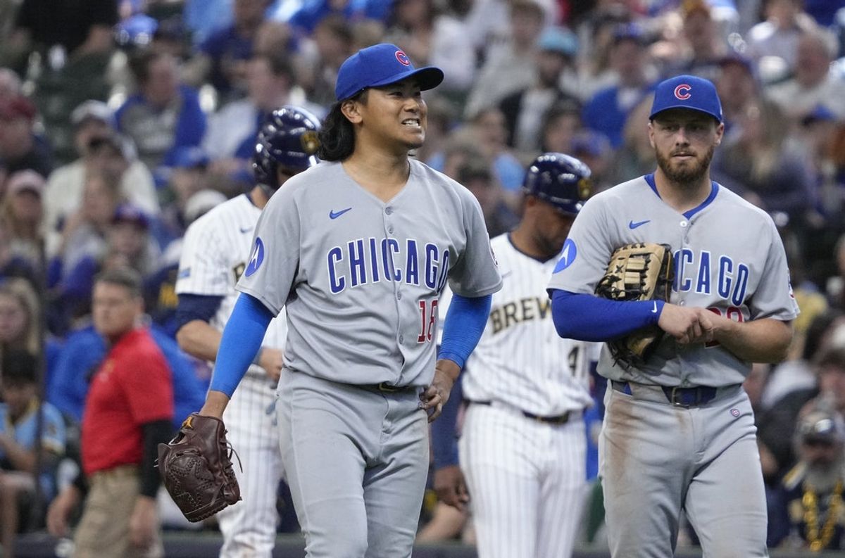 May 4, 2025; Milwaukee, Wisconsin, USA; Chicago Cubs pitcher Shota Imanaga (18) walks toward the mound to be checked out by a trainer after being injured against the Milwaukee Brewers in the sixth inning at American Family Field. Mandatory Credit: Michael McLoone-Imagn Images