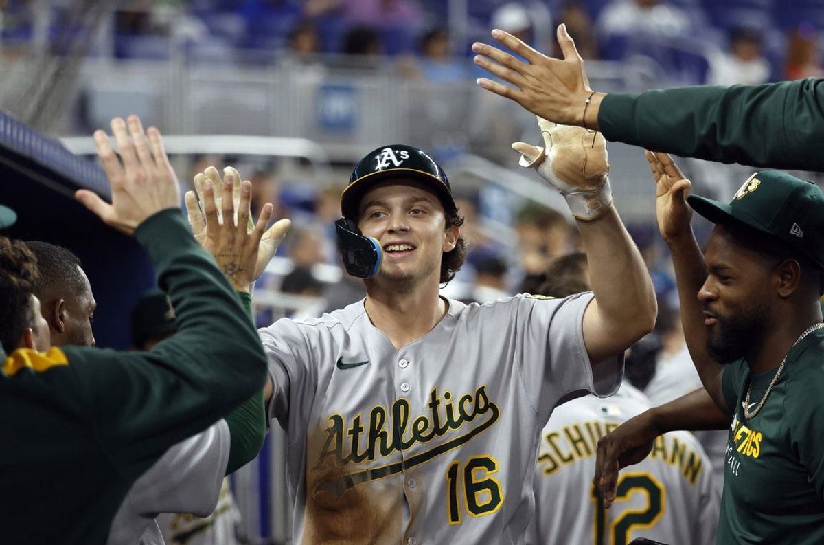 May 4, 2025; Miami, Florida, USA;  Oakland Athletics first baseman Nick Kurtz (16) is greeted in the dugout by teammates after scoring against the Miami Marlins during the ninth inning at loanDepot Park. Mandatory Credit: Rhona Wise-Imagn Images