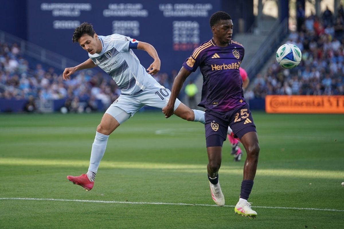 May 4, 2025; Kansas City, Kansas, USA; LA Galaxy defender Emiro Garces (25) controls the ball as Sporting Kansas City forward Daniel Salloi (10) defends during the first half at Children's Mercy Park. Mandatory Credit: Denny Medley-Imagn Images
