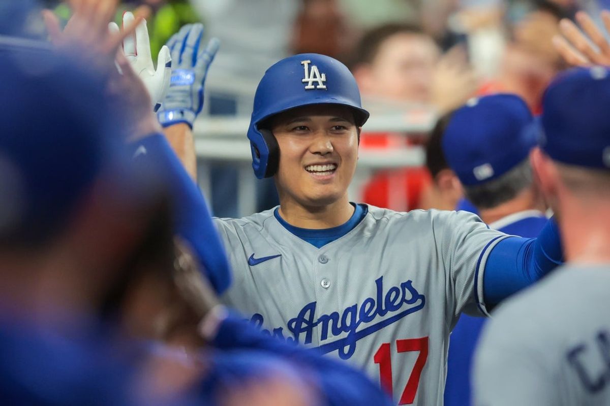 May 5, 2025; Miami, Florida, USA; Los Angeles Dodgers designated hitter Shohei Ohtani (17) celebrates with teammates after hitting a two-run home run against the Miami Marlins during the fifth inning at loanDepot Park. Mandatory Credit: Sam Navarro-Imagn Images