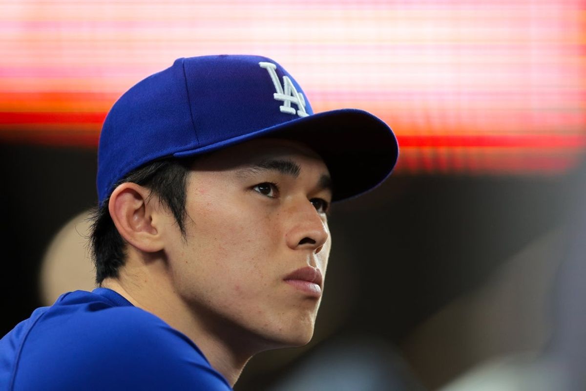 May 5, 2025; Miami, Florida, USA; Los Angeles Dodgers starting pitcher Roki Sasaki (11) looks on from the dugout against the Miami Marlins during the ninth inning at loanDepot Park. Mandatory Credit: Sam Navarro-Imagn Images