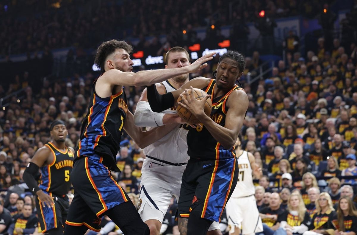 May 5, 2025; Oklahoma City, Oklahoma, USA; Oklahoma City Thunder forward Jalen Williams (8) and forward Chet Holmgren (7) steal the ball from Denver Nuggets center Nikola Jokic (15) during the second quarter during game one of the second round for the 2025 NBA Playoffs at Paycom Center. Mandatory Credit: Alonzo Adams-Imagn Images