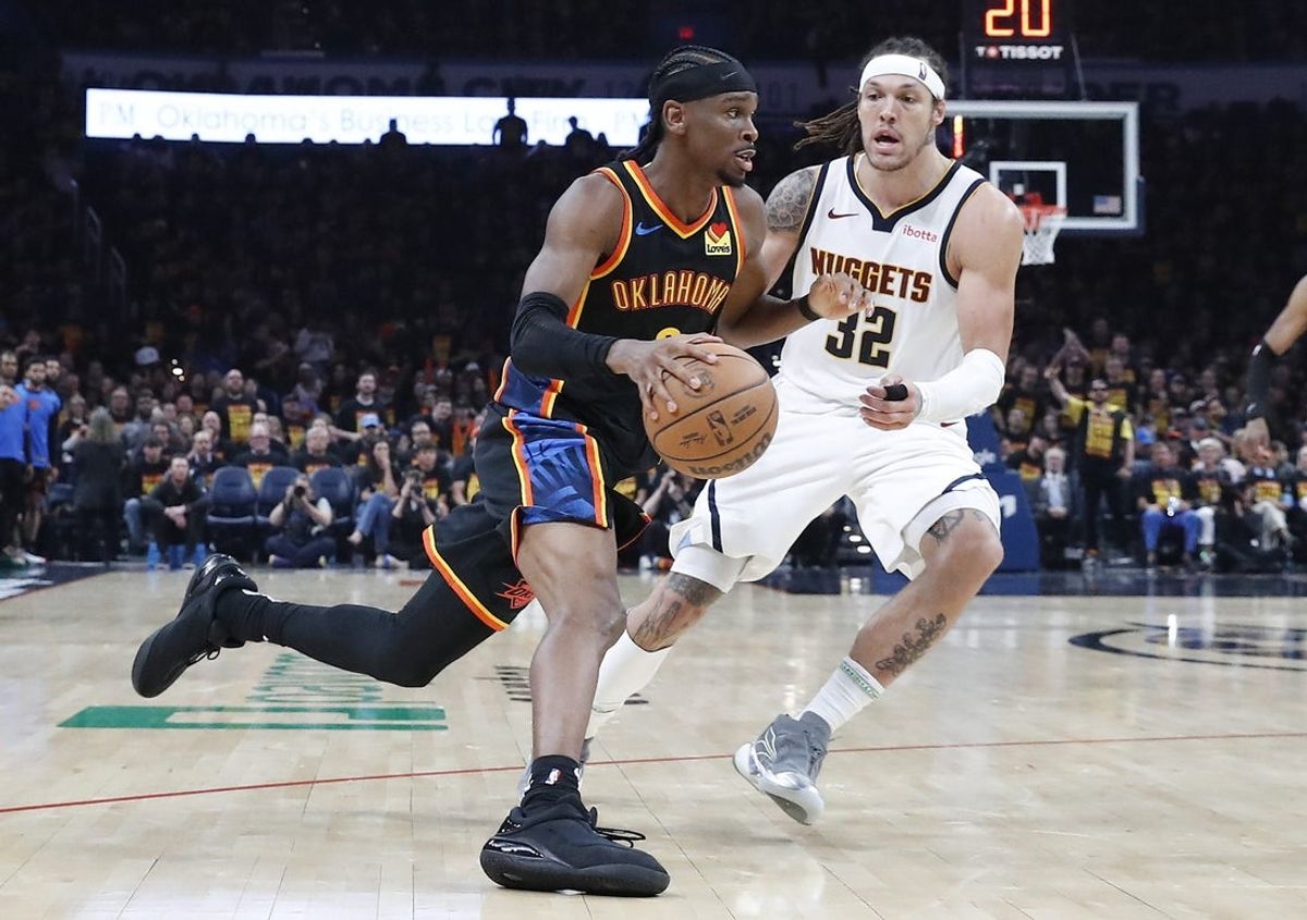 May 5, 2025; Oklahoma City, Oklahoma, USA; Oklahoma City Thunder guard Shai Gilgeous-Alexander (2) drives around Denver Nuggets forward Aaron Gordon (32) during the second half during game one of the second round for the 2025 NBA Playoffs at Paycom Center. Mandatory Credit: Alonzo Adams-Imagn Images
