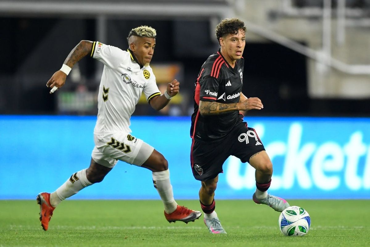 May 6, 2025; Washington, District of Columbia, USA; D.C. United forward Fidel Barajas (99) controls the ball against Charleston Battery midfielder Juan Torres (80) during the second half of the game at Audi Field. Mandatory Credit: Hannah Foslien-Imagn Images