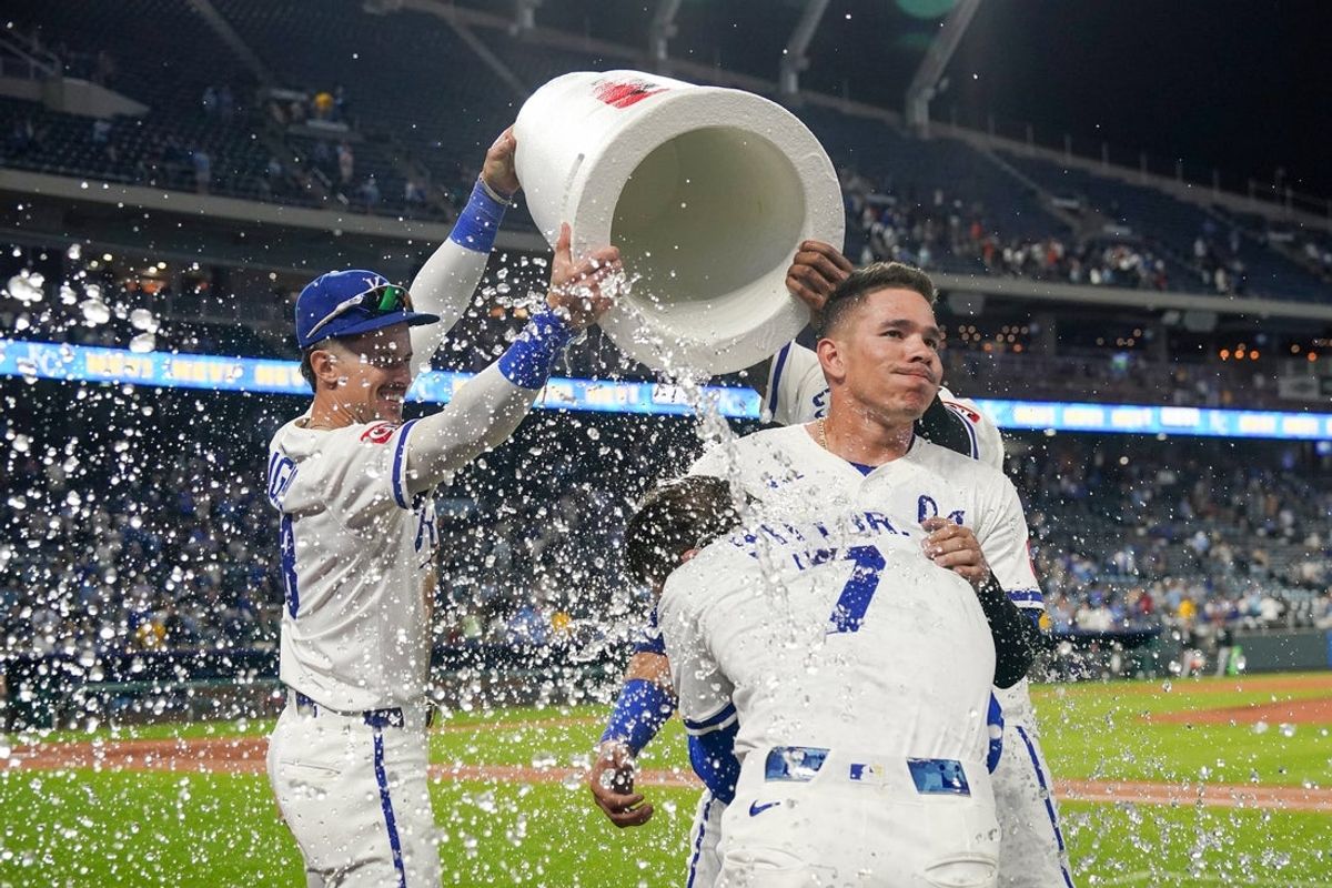 May 6, 2025; Kansas City, Missouri, USA; Kansas City Royals shortstop Bobby Witt Jr. (7) and catcher Freddy Fermin (34) are doused by right fielder Cavan Biggio (18) and designated hitter Salvador Perez (13) after the win over the Chicago White Sox at Kauffman Stadium. Mandatory Credit: Denny Medley-Imagn Images