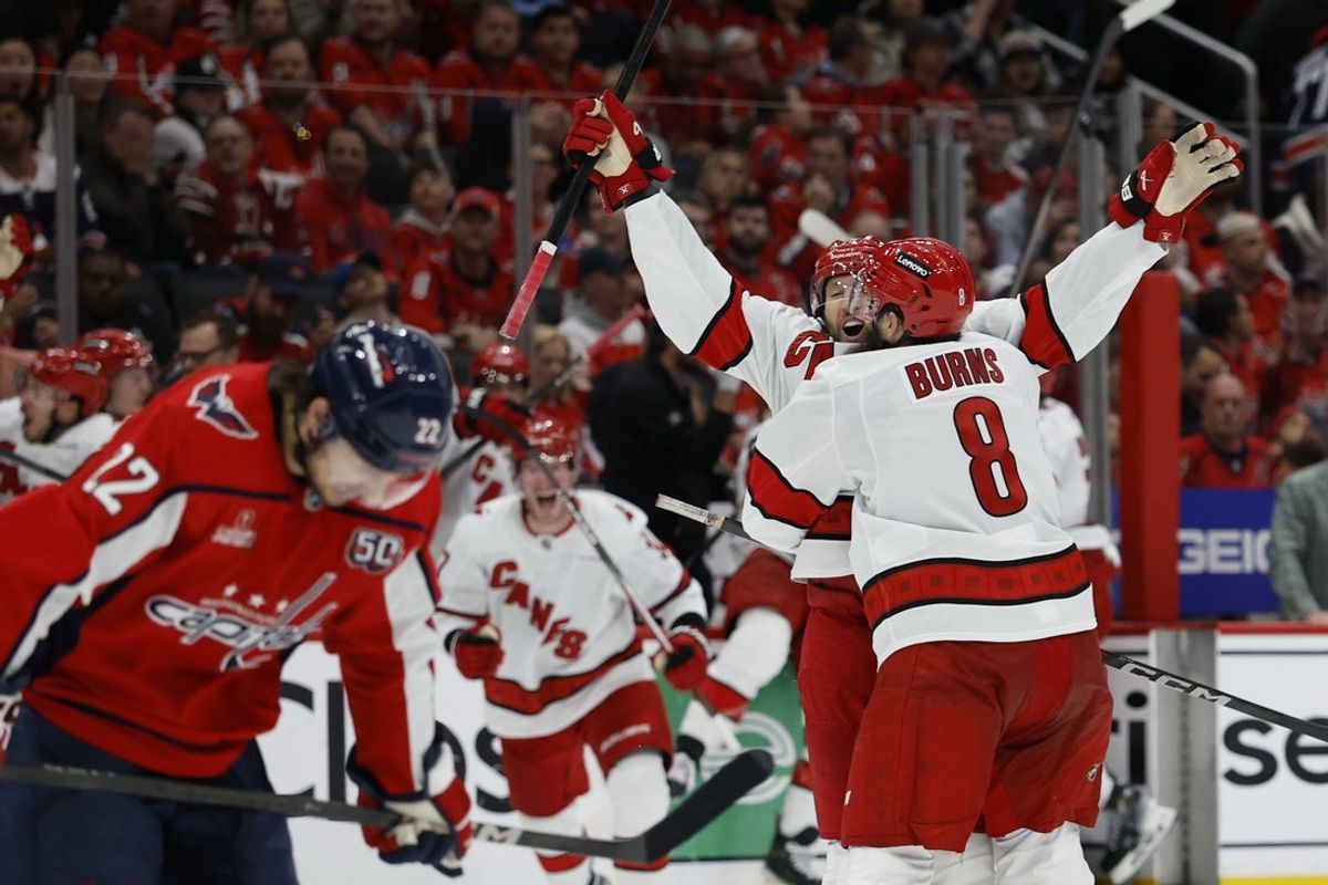 May 6, 2025; Washington, District of Columbia, USA; Carolina Hurricanes defenseman Jaccob Slavin (74) celebrates with teammates after scoring the game winning goal in overtime against the Washington Capitals in game one of the second round of the 2025 Stanley Cup Playoffs at Capital One Arena. Mandatory Credit: Geoff Burke-Imagn Images