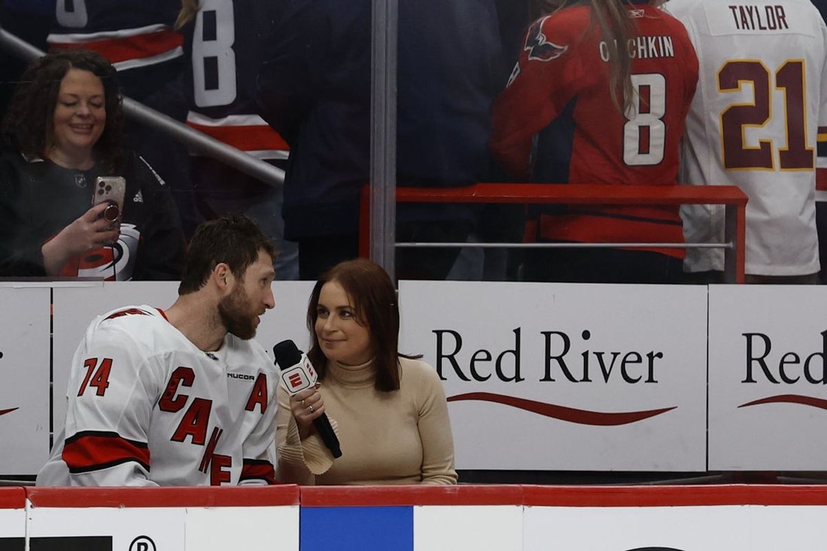 May 6, 2025; Washington, District of Columbia, USA; Carolina Hurricanes defenseman Jaccob Slavin (74) is interviewed by ESPN reporter Emily Kaplan (R) after scoring the overtime goal against the Washington Capitals in game one of the second round of the 2025 Stanley Cup Playoffs at Capital One Arena. Mandatory Credit: Geoff Burke-Imagn Images