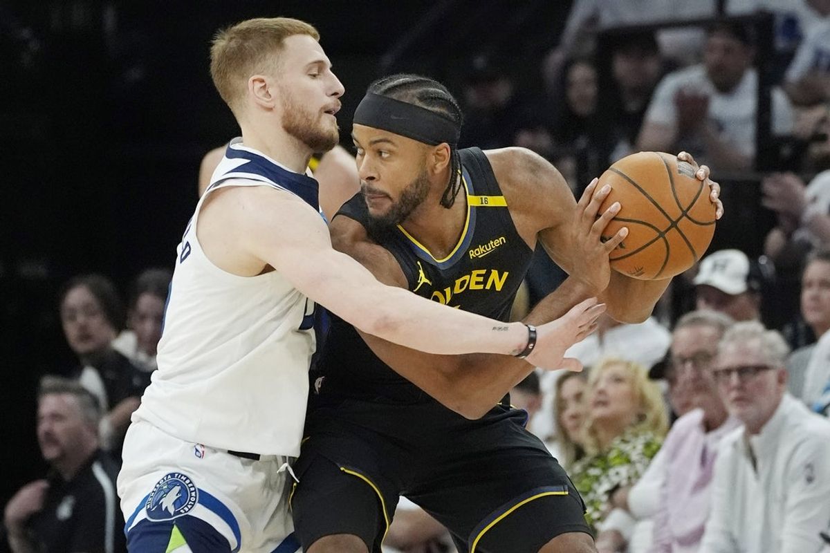 May 6, 2025; Minneapolis, Minnesota, USA; Minnesota Timberwolves guard Donte DiVincenzo (0) defends against Golden State Warriors forward Moses Moody (4) during game one of the second round for the 2025 NBA Playoffs at Target Center. Mandatory Credit: Bruce Kluckhohn-Imagn Images