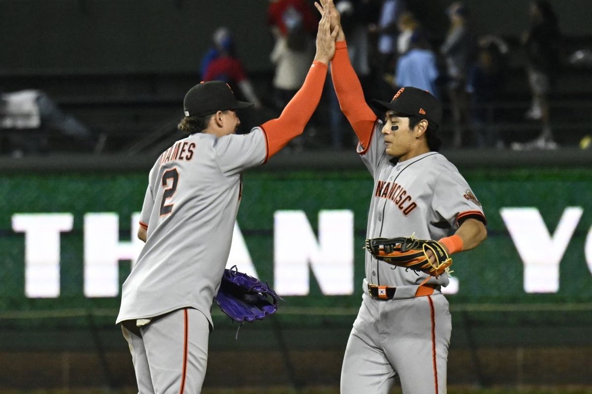 May 6, 2025; Chicago, Illinois, USA;  San Francisco Giants shortstop Willy Adames (2) high fives outfielder Jung Hoo Lee (51) after the game against the Chicago Cubs at Wrigley Field. Mandatory Credit: Matt Marton-Imagn Images