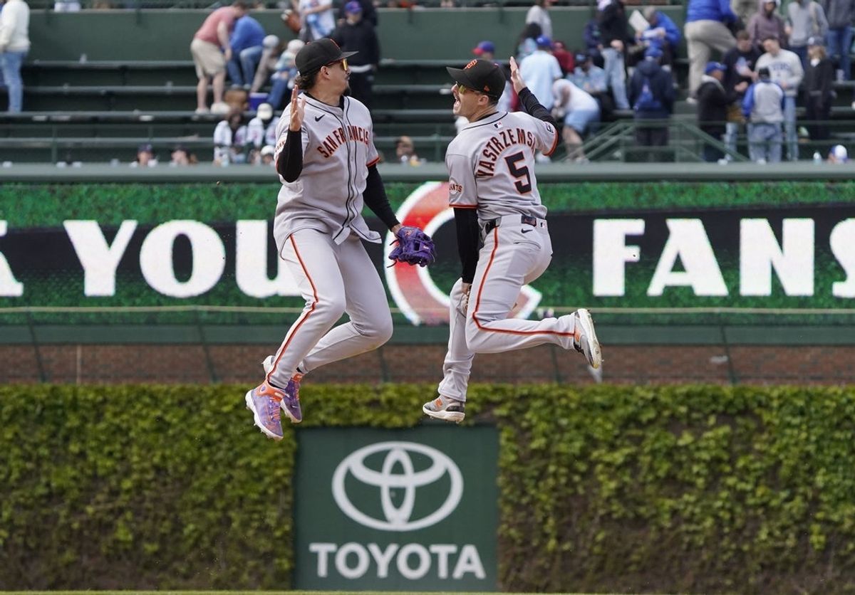 May 7, 2025; Chicago, Illinois, USA; San Francisco Giants shortstop Willy Adames (2) and outfielder Mike Yastrzemski (5) celebrate their win against the Chicago Cubs at Wrigley Field. Mandatory Credit: David Banks-Imagn Images