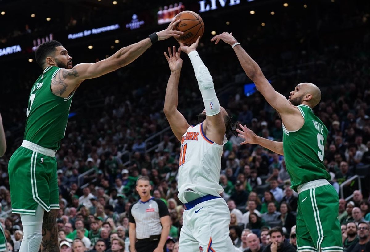 May 7, 2025; Boston, Massachusetts, USA; Boston Celtics forward Jayson Tatum (0) and guard Derrick White (9) defend against New York Knicks guard Jalen Brunson (11)  in the second quarter during game two of the second round for the 2025 NBA Playoffs at TD Garden. Mandatory Credit: David Butler II-Imagn Images