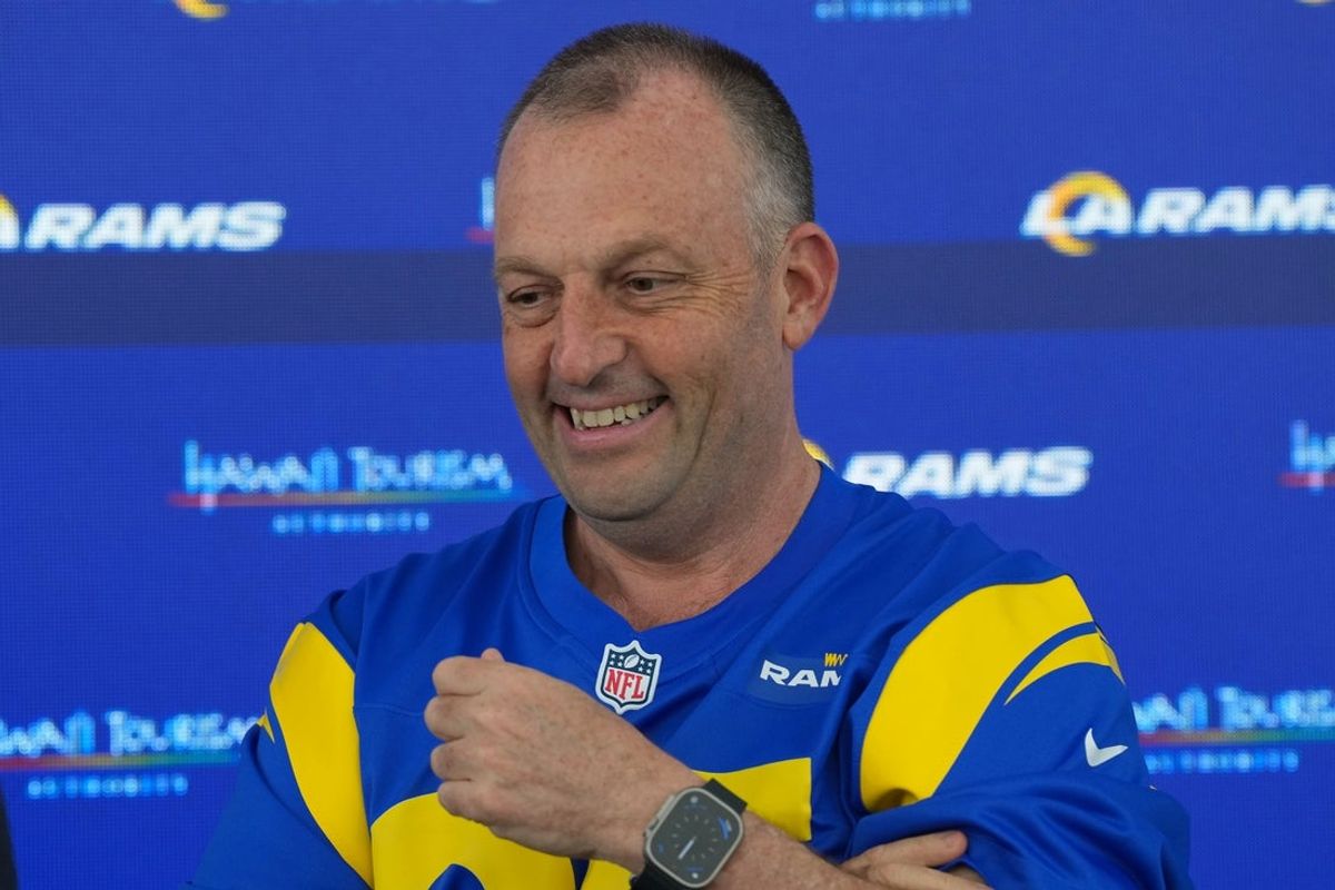 May 7, 2025; Woodland Hills, CA, USA; Hawaii governor Josh Green, M.D., poses in a Los Angeles Rams jersey at a press conference at the Rams Practice Facility to announce a partnership between the Rams and the Hawaii Tourism Authority to hold minicamp in Maui. Mandatory Credit: Kirby Lee-Imagn Images