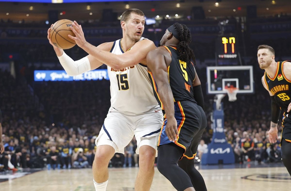 May 7, 2025; Oklahoma City, Oklahoma, USA; Denver Nuggets center Nikola Jokic (15) drives to the basket against Oklahoma City Thunder guard Luguentz Dort (5) in the first quarter during game two of the second round for the 2025 NBA Playoffs at Paycom Center. Mandatory Credit: Alonzo Adams-Imagn Images