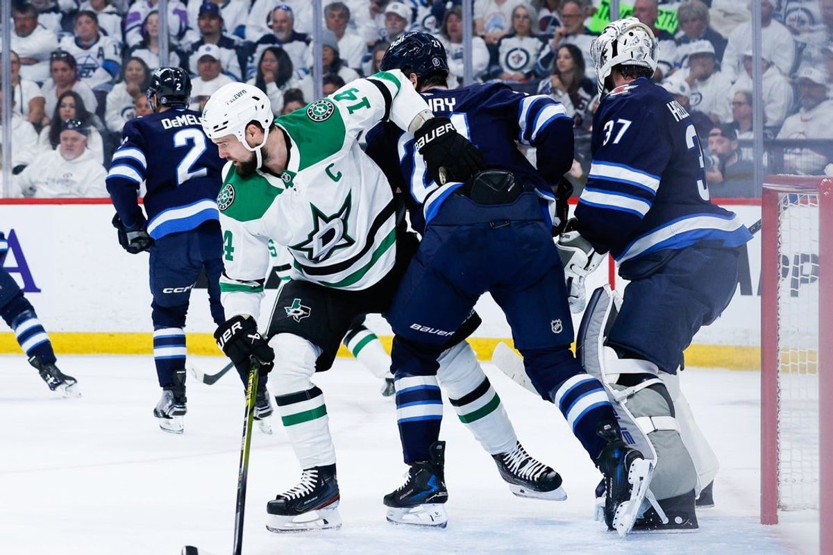 May 7, 2025; Winnipeg, Manitoba, CAN; Dallas Stars forward Jamie Benn (14) jostles for position with Winnipeg Jets defenseman Hayden Fleury (24) during the first period in game one of the second round of the 2025 Stanley Cup Playoffs at Canada Life Centre. Mandatory Credit: Terrence Lee-Imagn Images