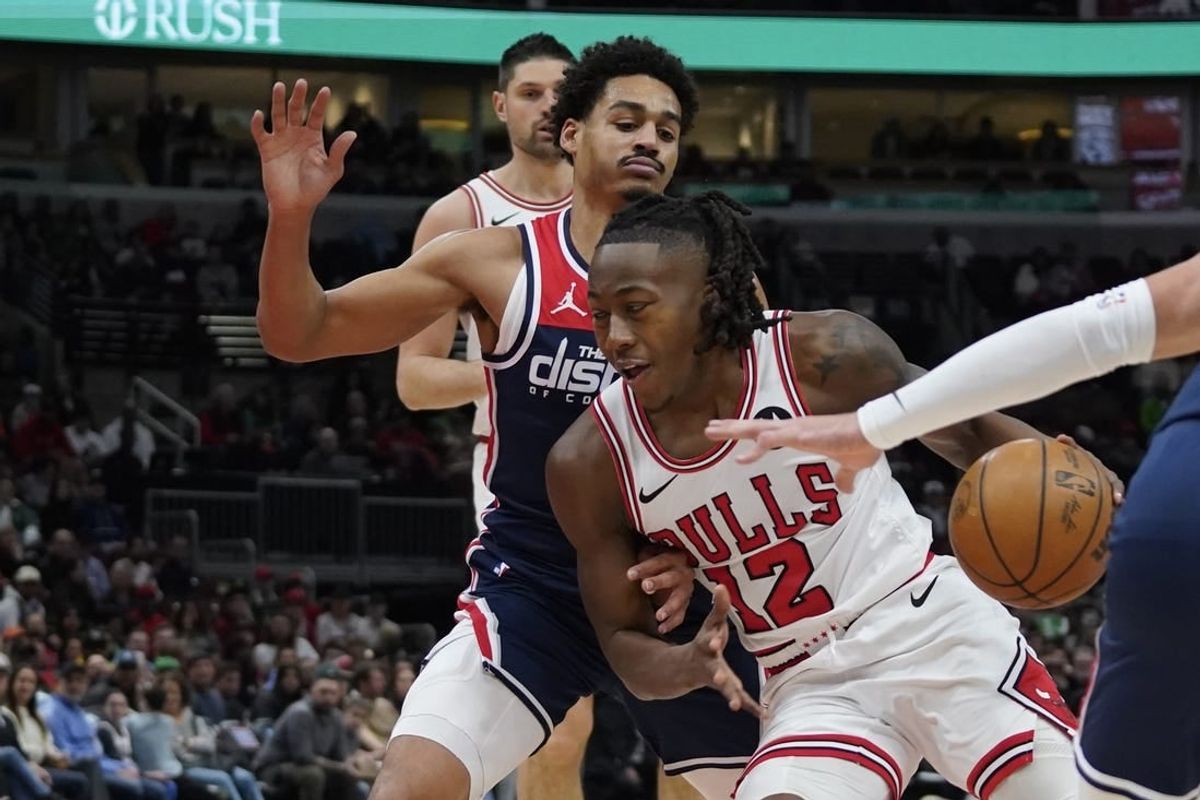Mar 16, 2024; Chicago, Illinois, USA; Washington Wizards guard Jordan Poole (13) defends Chicago Bulls guard Ayo Dosunmu (12) during the first quarter at United Center.
