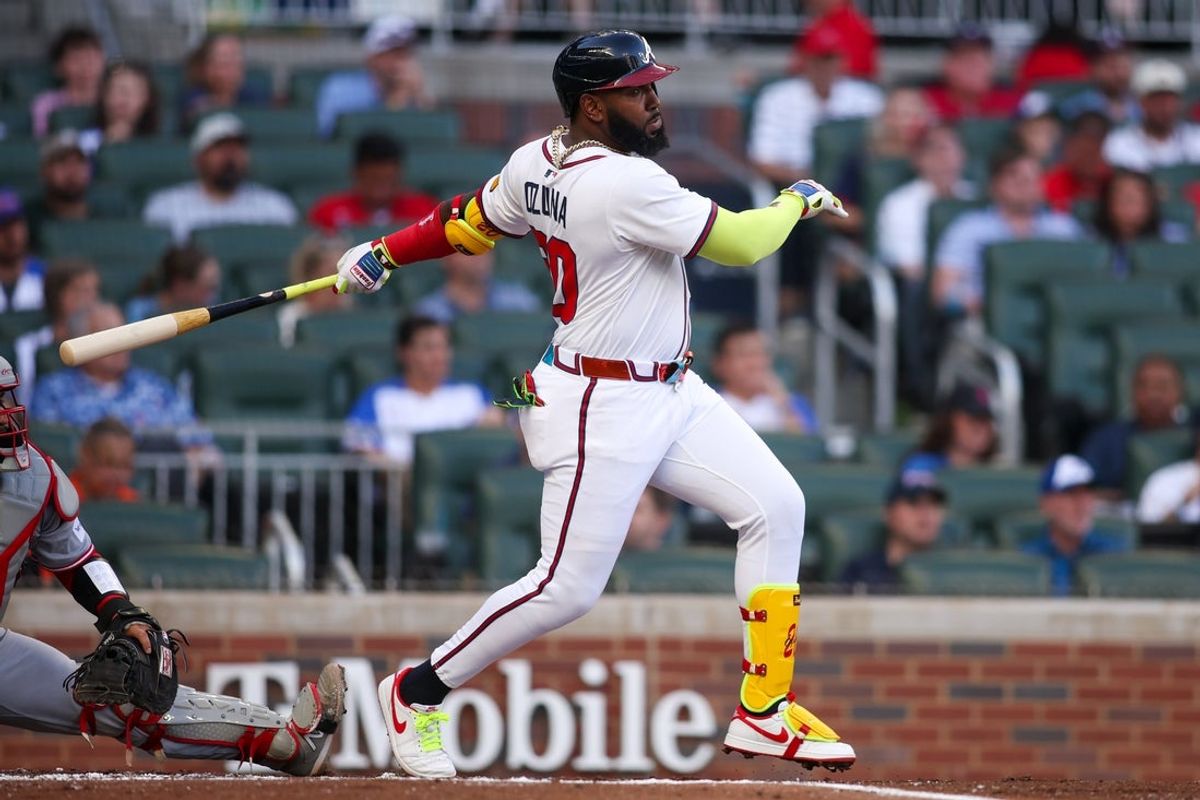 May 8, 2025; Atlanta, Georgia, USA; Atlanta Braves designated hitter Marcell Ozuna (20) hits a single against the Cincinnati Reds in the first inning at Truist Park. Mandatory Credit: Brett Davis-Imagn Images