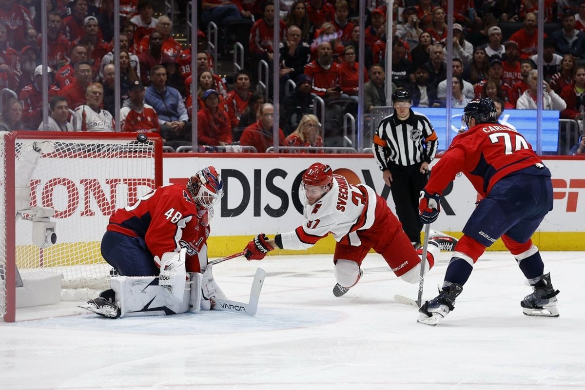 May 8, 2025; Washington, District of Columbia, USA; Washington Capitals goaltender Logan Thompson (48) makes a save on Carolina Hurricanes right wing Andrei Svechnikov (37) as Capitals defenseman John Carlson (74) defends in the second period in game two of the second round of the 2025 Stanley Cup Playoffs at Capital One Arena. Mandatory Credit: Geoff Burke-Imagn Images