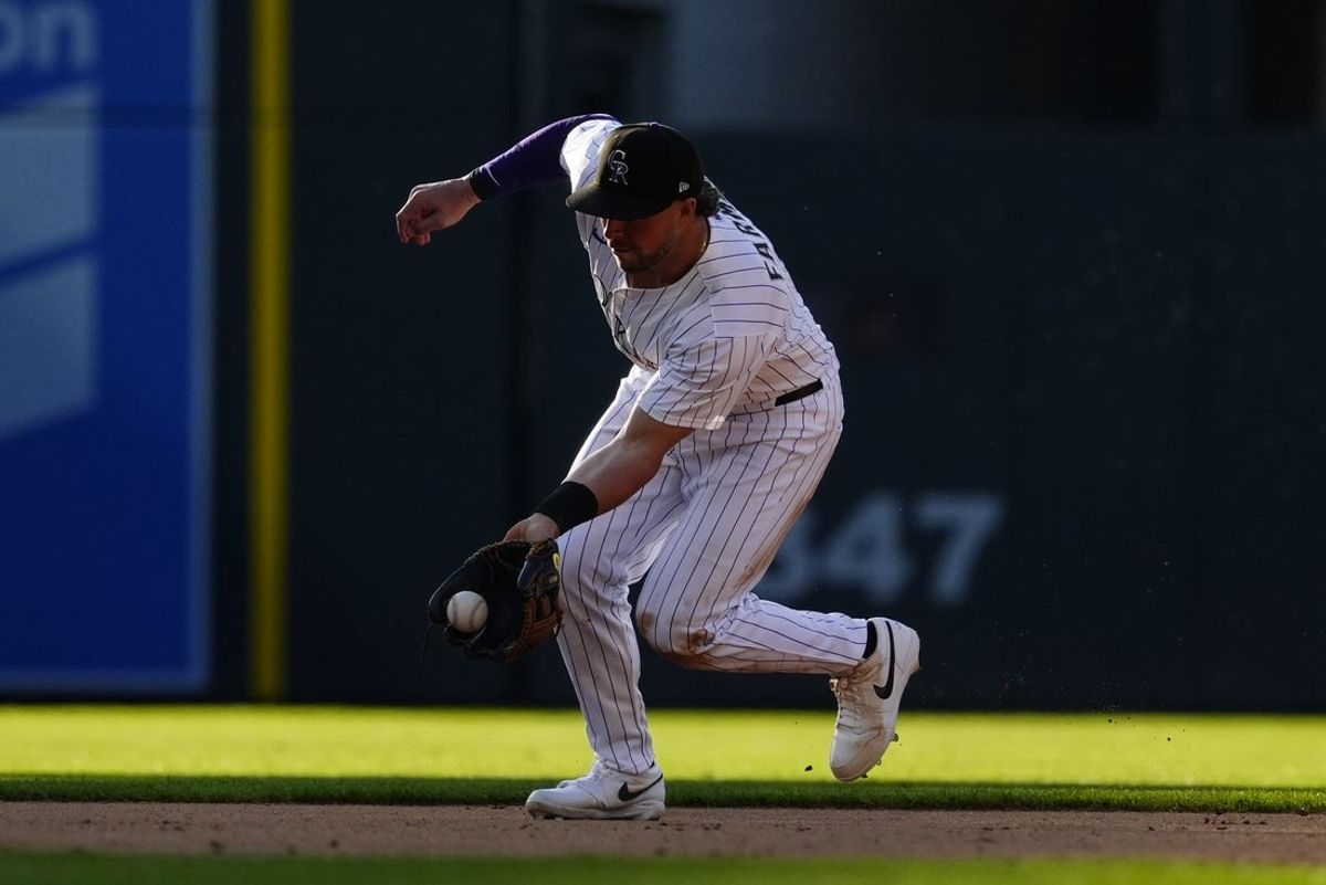 May 8, 2025; Denver, Colorado, USA; Colorado Rockies second baseman Kyle Farmer (6) fields the ball in the eighth inning against the Detroit Tigers at Coors Field. Mandatory Credit: Ron Chenoy-Imagn Images