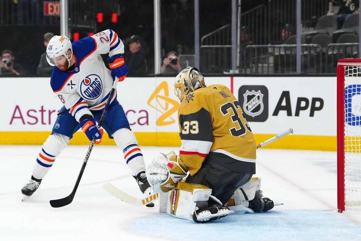 May 8, 2025; Las Vegas, Nevada, USA; Edmonton Oilers right wing Connor Brown (28) deflects the puck toward Vegas Golden Knights goaltender Adin Hill (33) during the first period of game two of the second round of the 2025 Stanley Cup Playoffs at T-Mobile Arena. Mandatory Credit: Stephen R. Sylvanie-Imagn Images