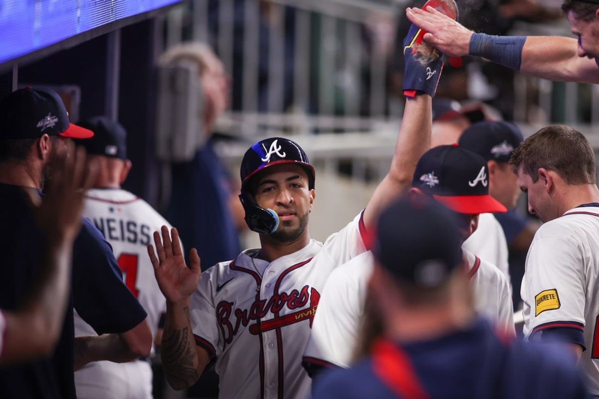May 8, 2025; Atlanta, Georgia, USA; Atlanta Braves outfielder Eddie Rosario (9) celebrates with teammates after scoring a run against the Cincinnati Reds in the ninth inning at Truist Park. Mandatory Credit: Brett Davis-Imagn Images