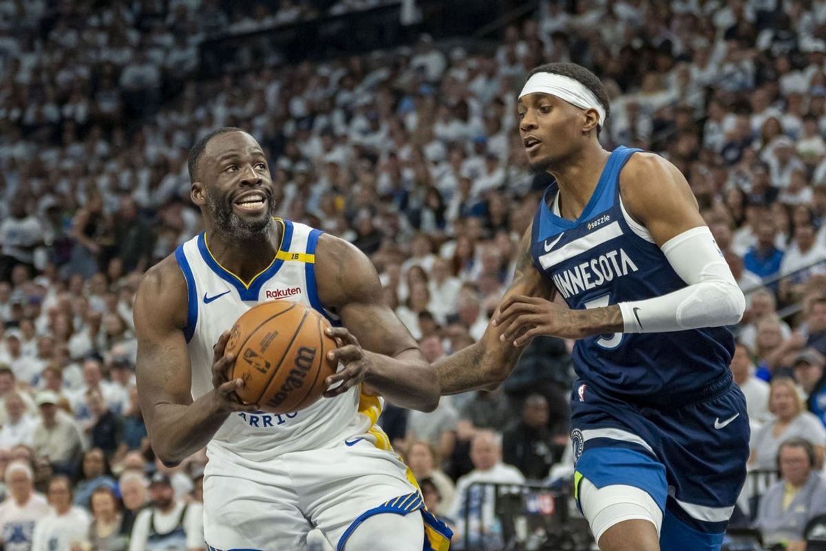 May 8, 2025; Minneapolis, Minnesota, USA; Golden State Warriors forward Draymond Green (23) drives to the basket past Minnesota Timberwolves forward Jaden McDaniels (3) in the second half during game two of the second round for the 2025 NBA Playoffs at Target Center. Mandatory Credit: Jesse Johnson-Imagn Images