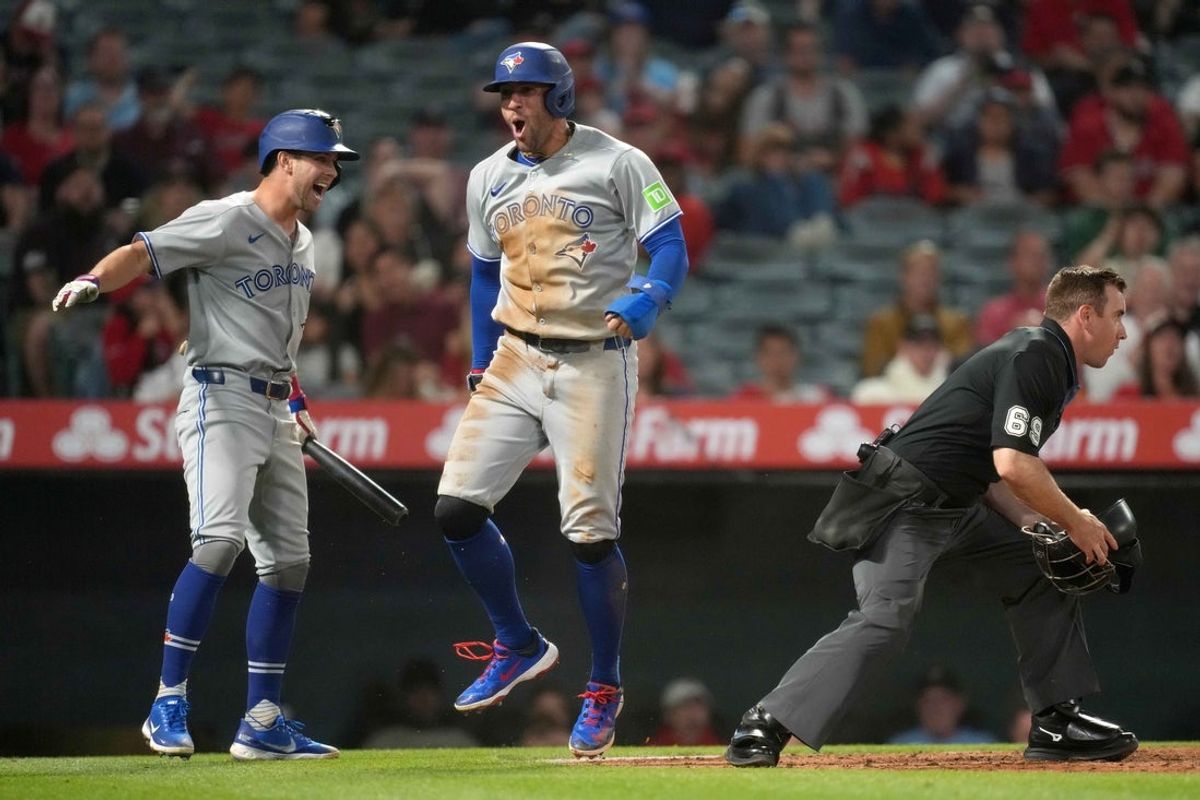 May 8, 2025; Anaheim, California, USA; Toronto Blue Jays designated hitter George Springer (4) celebrates with second baseman Ernie Clement (22) after scoring on a throwing error in the sixth inning against the Los Angeles Angels at Angel Stadium. Mandatory Credit: Kirby Lee-Imagn Images