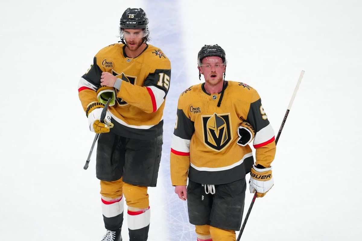 May 8, 2025; Las Vegas, Nevada, USA; Vegas Golden Knights defenseman Noah Hanifin (15) and center Jack Eichel (9) leave the ice after the Edmonton Oilers defeated the Golden Knights 5-4 in overtime of game two of the second round of the 2025 Stanley Cup Playoffs at T-Mobile Arena. Mandatory Credit: Stephen R. Sylvanie-Imagn Images