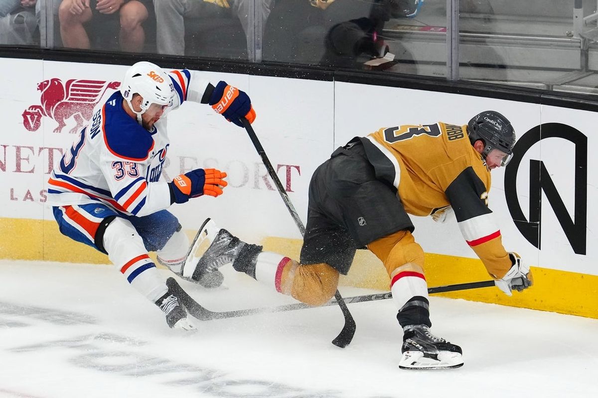 May 8, 2025; Las Vegas, Nevada, USA; Edmonton Oilers left wing Viktor Arvidsson (33) trips Vegas Golden Knights defenseman Brayden McNabb (3) during an overtime period of game two of the second round of the 2025 Stanley Cup Playoffs at T-Mobile Arena. Mandatory Credit: Stephen R. Sylvanie-Imagn Images