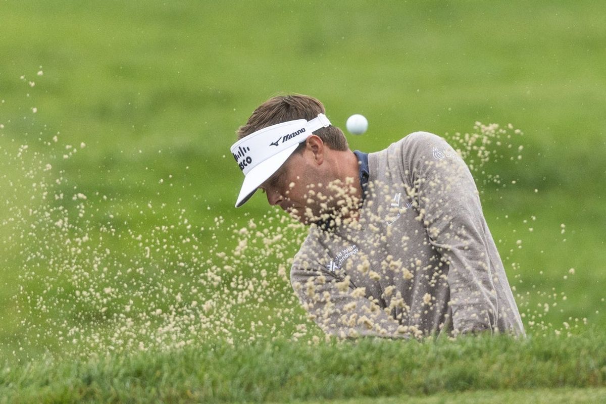 May 9, 2025; Philadelphia, Pennsylvania, USA; Keith Mitchell plays a shot from a bunker on the sixth hole during the second round of the Truist Championship golf tournament. Mandatory Credit: Bill Streicher-Imagn Images