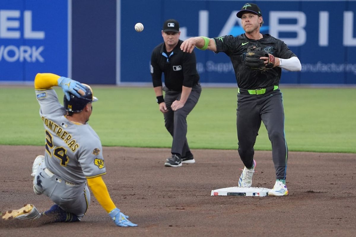 May 9, 2025; Tampa, Florida, USA; Tampa Bay Rays shortstop Taylor Walls (6) makes the double play as Milwaukee Brewers catcher William Contreras (24) slides into second during the first inning at George M. Steinbrenner Field. Mandatory Credit: Dave Nelson-Imagn Images