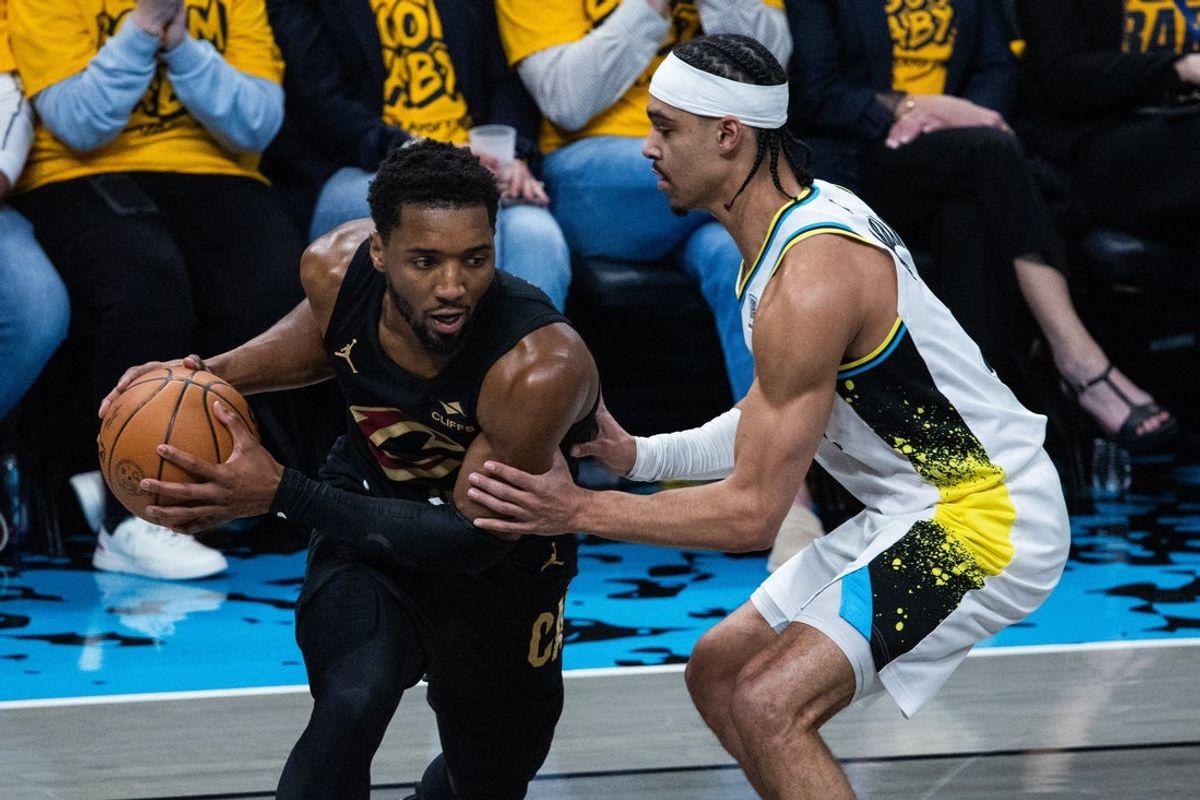 May 9, 2025; Indianapolis, Indiana, USA; Cleveland Cavaliers guard Donovan Mitchell (45) holds the ball while  Indiana Pacers guard Andrew Nembhard (2) defends during game three of the second round for the 2025 NBA Playoffs at Gainbridge Fieldhouse. Mandatory Credit: Trevor Ruszkowski-Imagn Images