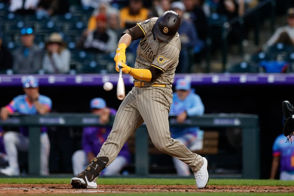 May 9, 2025; Denver, Colorado, USA; San Diego Padres designated hitter Gavin Sheets (30) hits an RBI double in the fifth inning against the Colorado Rockies at Coors Field. Mandatory Credit: Isaiah J. Downing-Imagn Images