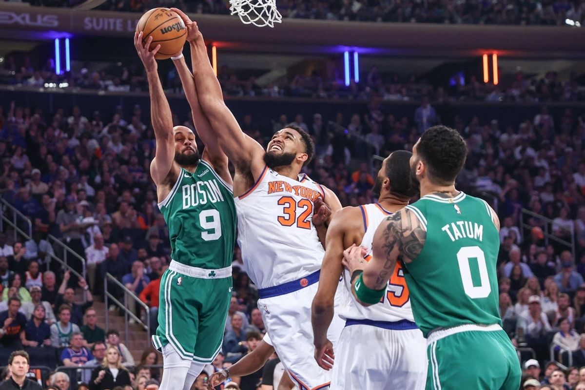 May 10, 2025; New York, New York, USA; Boston Celtics guard Derrick White (9) and New York Knicks center Karl-Anthony Towns (32) fight for a rebound in the first quarter during game three of the second round for the 2025 NBA Playoffs at Madison Square Garden. Mandatory Credit: Wendell Cruz-Imagn Images