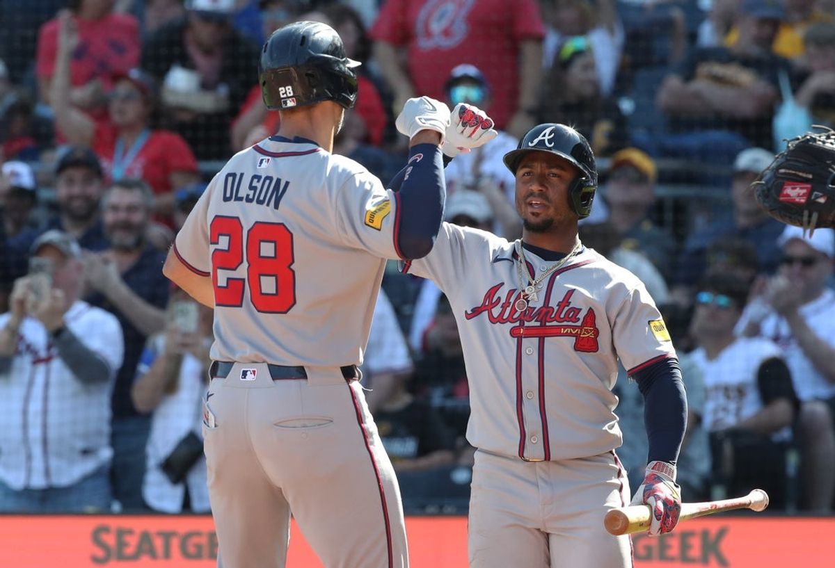 May 10, 2025; Pittsburgh, Pennsylvania, USA;  Atlanta Braves second baseman Ozzie Albies (right) congratulates first baseman Matt Olson (28) crossing hime plate on a solo home run against the Pittsburgh Pirates during the third inning at PNC Park. Mandatory Credit: Charles LeClaire-Imagn Images