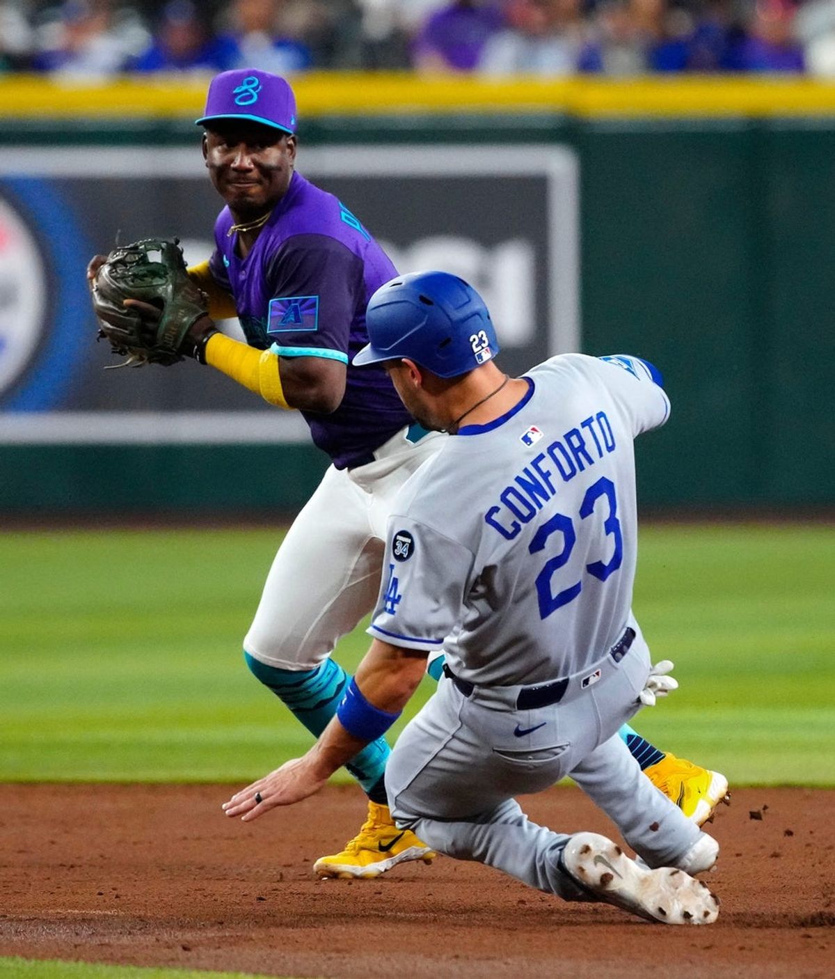 Diamondbacks short stop Geraldo Perdomo (2) records a force out at second on Dodgers Michael Conforto (23) during a game at Chase Field on May 10, 2025, in Phoenix.