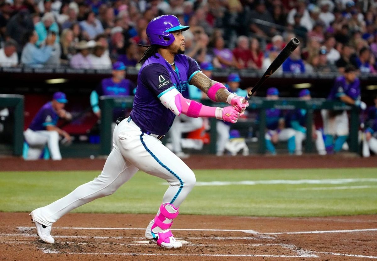 Diamondbacks second baseman Ketel Marte (4) hits a sacrifice hit to score a run against the Dodgers in the third inning during a game at Chase Field on May 10, 2025, in Phoenix.