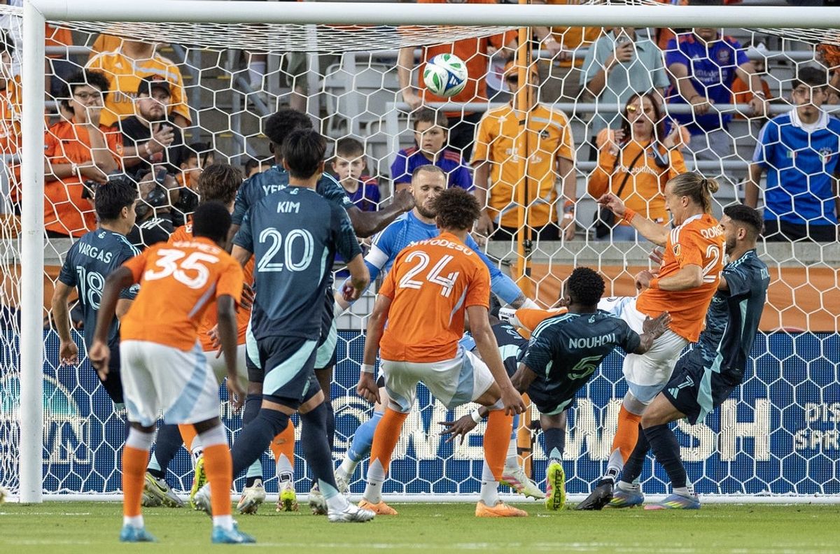 May 10, 2025; Houston, Texas, USA; Seattle Sounders FC defender Nouhou Tolo (5) clears the ball off the line against Houston Dynamo FC defender Obafemi Awodesu (24) in the first half  at Shell Energy Stadium. Mandatory Credit: Thomas Shea-Imagn Images