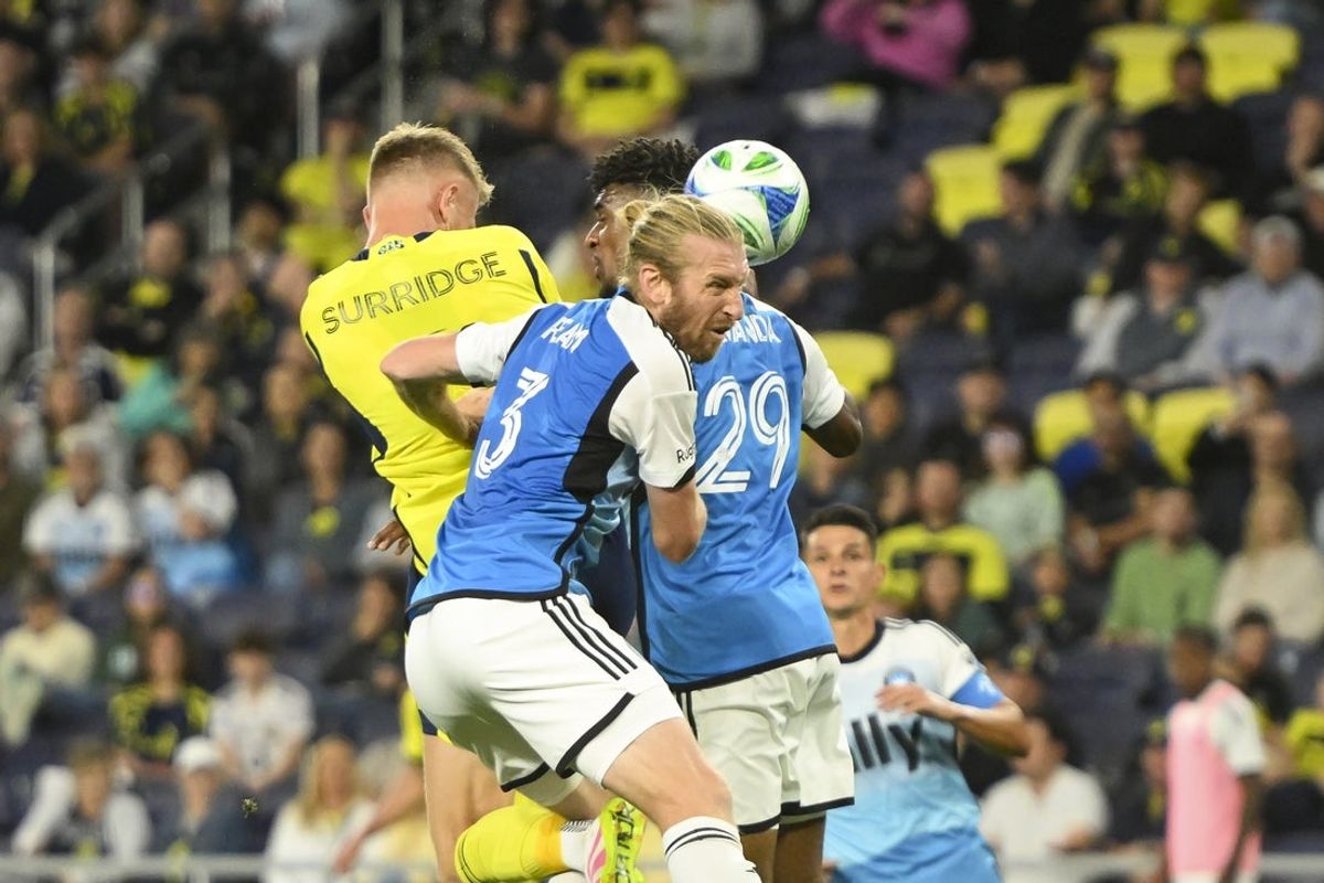 May 10, 2025; Nashville, Tennessee, USA;  Charlotte FC defender Tim Ream (3), defender Adilson Malanda (29) and Nashville SC forward Sam Surridge (9) fights for the ball during the first period at Geodis Park. Mandatory Credit: Steve Roberts-Imagn Images