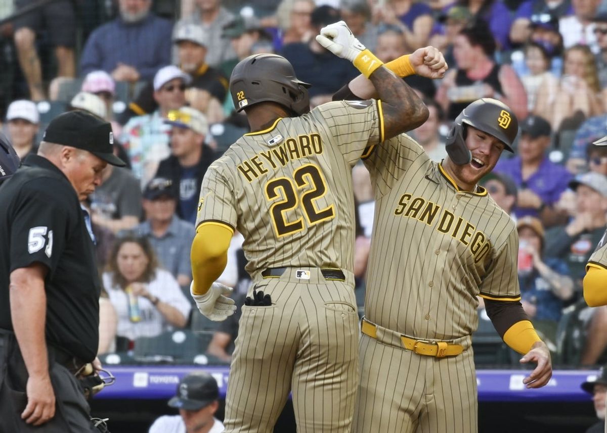 May 10, 2025; Denver, Colorado, USA; San Diego Padres outfielder Jason Heyward (22) is congratulated by first baseman Gavin Sheets (30) after his home run during the fourth inning against the Colorado Rockies  at Coors Field. Mandatory Credit: John Leyba-Imagn Images