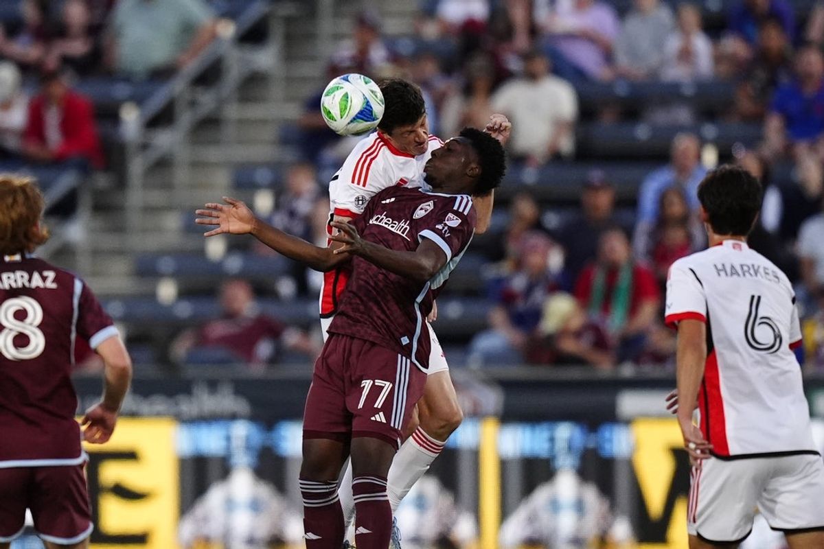 May 10, 2025; Commerce City, Colorado, USA; San Jose Earthquakes defender Daniel Munie (5) and Colorado Rapids forward Darren Yapi (77) battle for the ball in the first half at Dick's Sporting Goods Park. Mandatory Credit: Ron Chenoy-Imagn Images