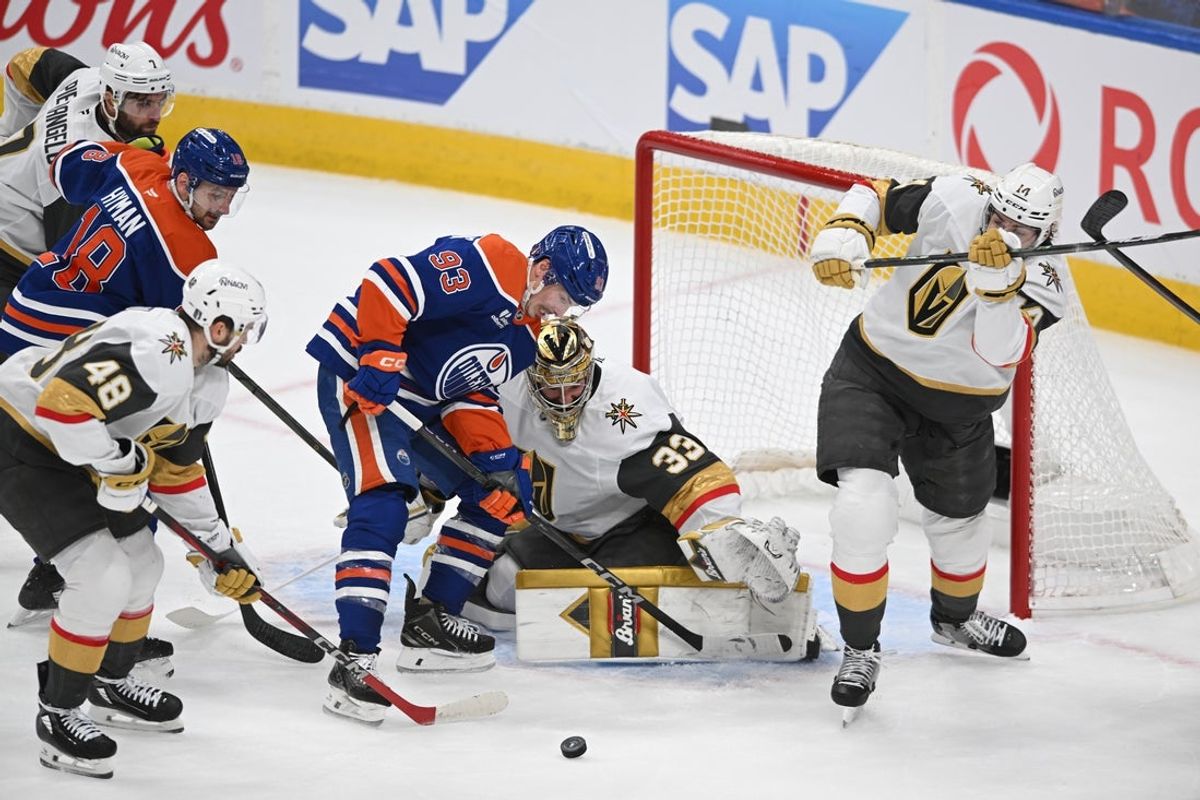 May 10, 2025; Edmonton, Alberta, CAN; Edmonton Oilers centre Ryan Nugent-Hopkins (93)  battles in front of Vegas Golden Knights goalie Adin Hill (33) during the first period in game three of the second round of the 2025 Stanley Cup Playoffs at Rogers Place. Mandatory Credit: Walter Tychnowicz-Imagn Images