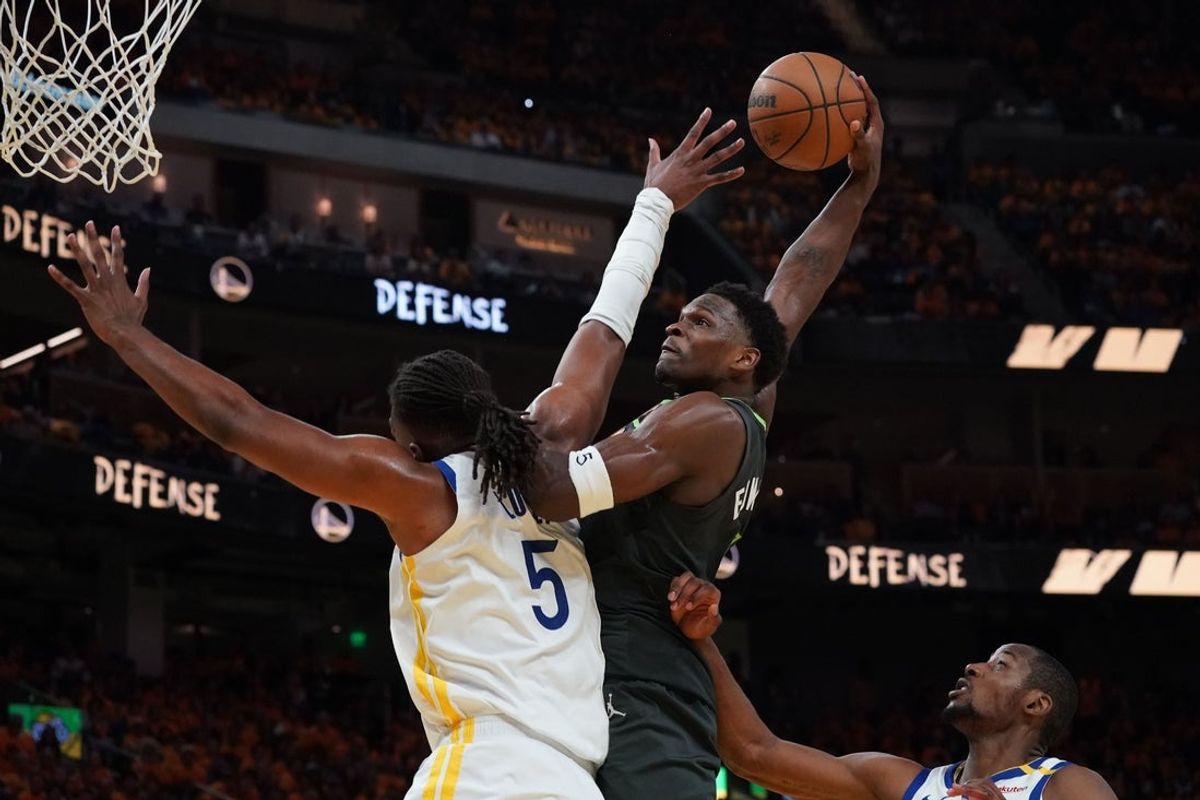 May 10, 2025; San Francisco, California, USA; Minnesota Timberwolves guard Anthony Edwards (5) dunks over Golden State Warriors forward Kevon Looney (5) in the third quarter during game three in the second round for the 2025 NBA Playoffs at Chase Center. Mandatory Credit: David Gonzales-Imagn Images
