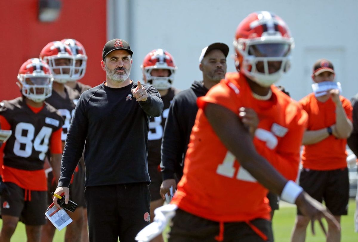 Cleveland Browns coach Kevin Stefanski watches quarterback Shedeur Sanders (12) participate in drills during day two of NFL rookie minicamp at the Cleveland Browns training facility May 10, 2025, in Berea, Ohio.