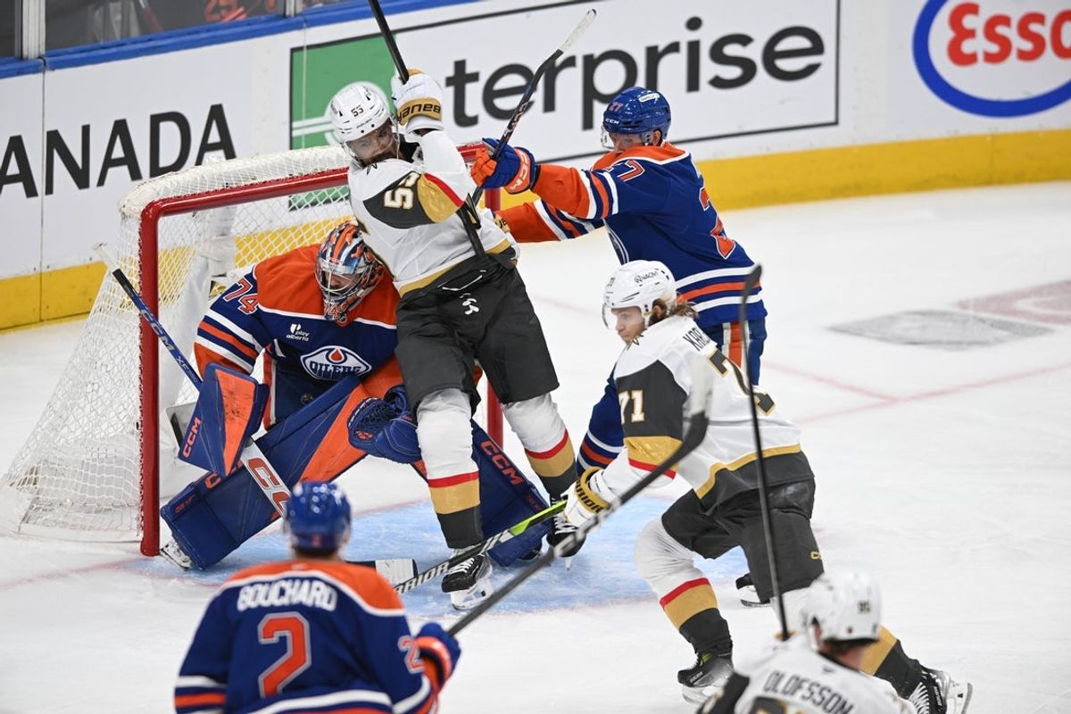 May 10, 2025; Edmonton, Alberta, CAN;  Edmonton Oilers goalie Stuart Skinner (74) looks for the puck while Vegas Golden Knights right winger Keegan Kolesar (55) and Oilers defenceman Brett Kulak (27) battle during the third period in game three of the second round of the 2025 Stanley Cup Playoffs at Rogers Place. Mandatory Credit: Walter Tychnowicz-Imagn Images