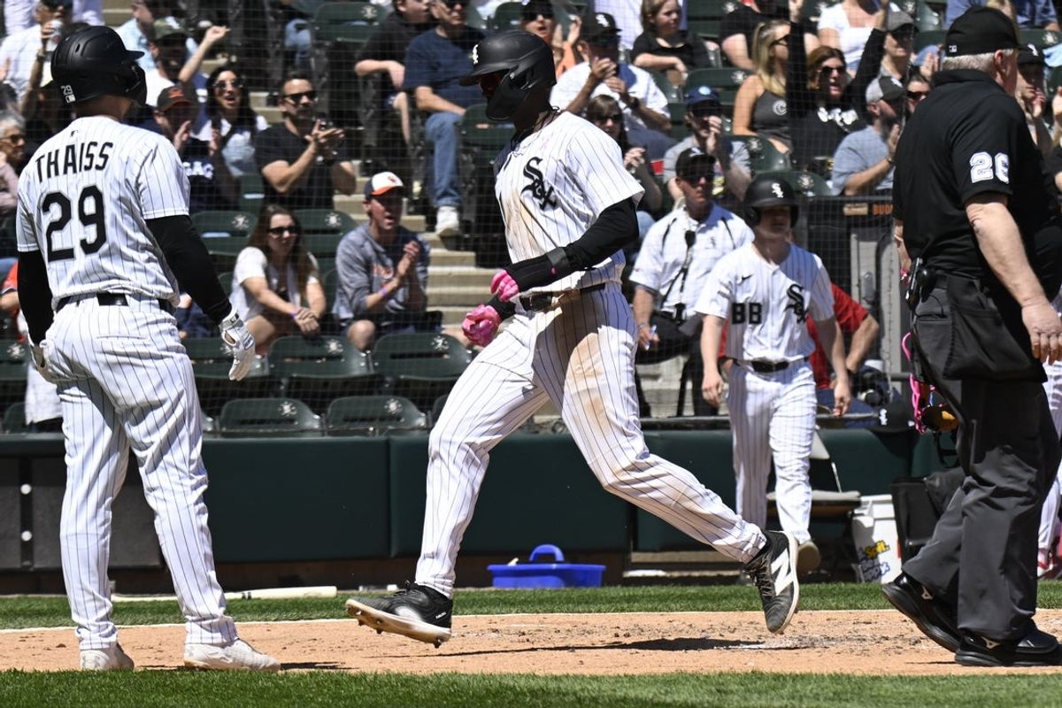 May 11, 2025; Chicago, Illinois, USA;  Chicago White Sox outfielder Michael A. Taylor (21) scores against the Miami Marlins during the third inning at Rate Field. Mandatory Credit: Matt Marton-Imagn Images