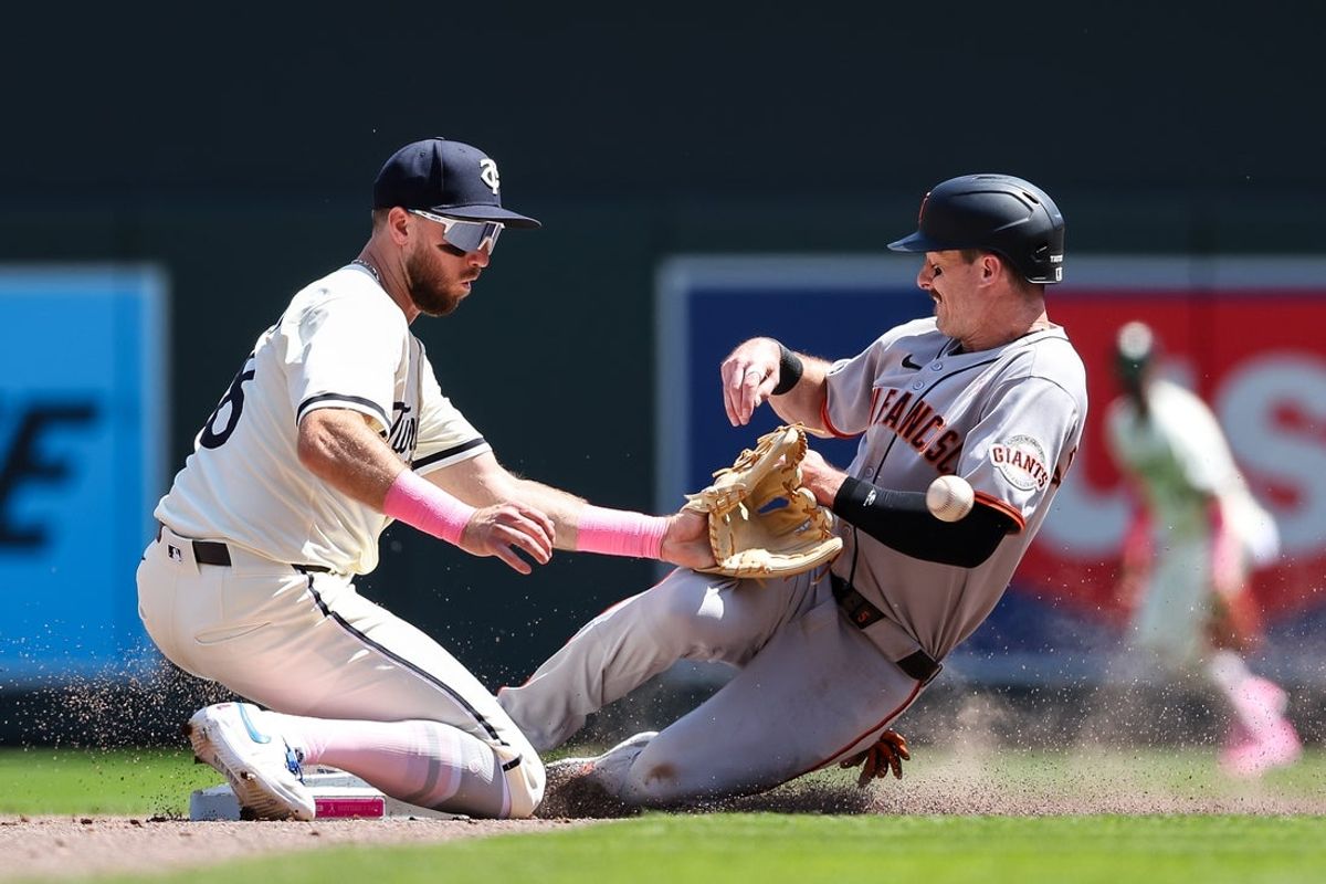 May 11, 2025; Minneapolis, Minnesota, USA; San Francisco Giants right fielder Mike Yastrzemski (5) steals second base against Minnesota Twins second baseman Kody Clemens (18) during the fifth inning at Target Field. Mandatory Credit: Matt Krohn-Imagn Images
