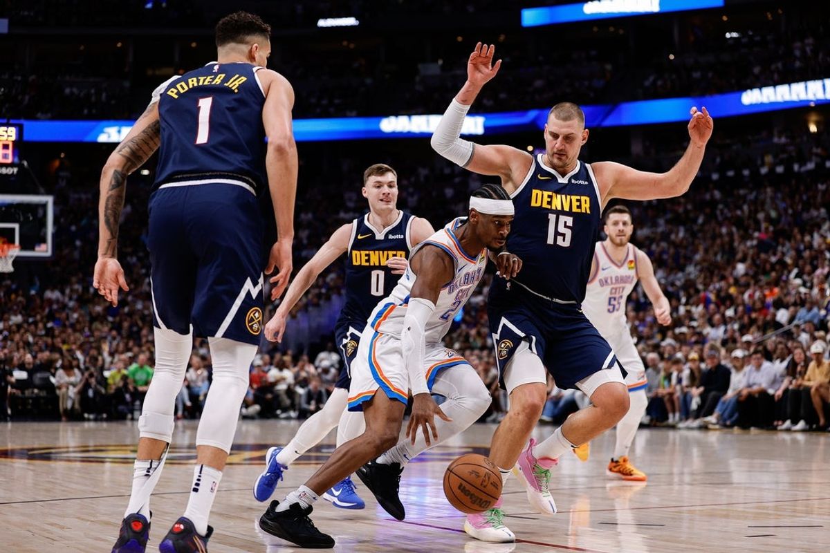 May 11, 2025; Denver, Colorado, USA; Oklahoma City Thunder guard Shai Gilgeous-Alexander (2) controls the ball against Denver Nuggets center Nikola Jokic (15) and guard Christian Braun (0) and forward Michael Porter Jr. (1) in the first quarter during game four of the second round of the 2025 NBA Playoffs at Ball Arena. Mandatory Credit: Isaiah J. Downing-Imagn Images
