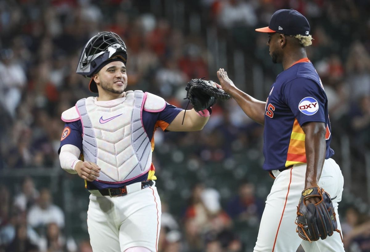 May 11, 2025; Houston, Texas, USA; Houston Astros starting pitcher Ronel Blanco (56) celebrates with catcher Yainer Diaz (21) after pitching during the eighth inning against the Cincinnati Reds at Daikin Park. Mandatory Credit: Troy Taormina-Imagn Images