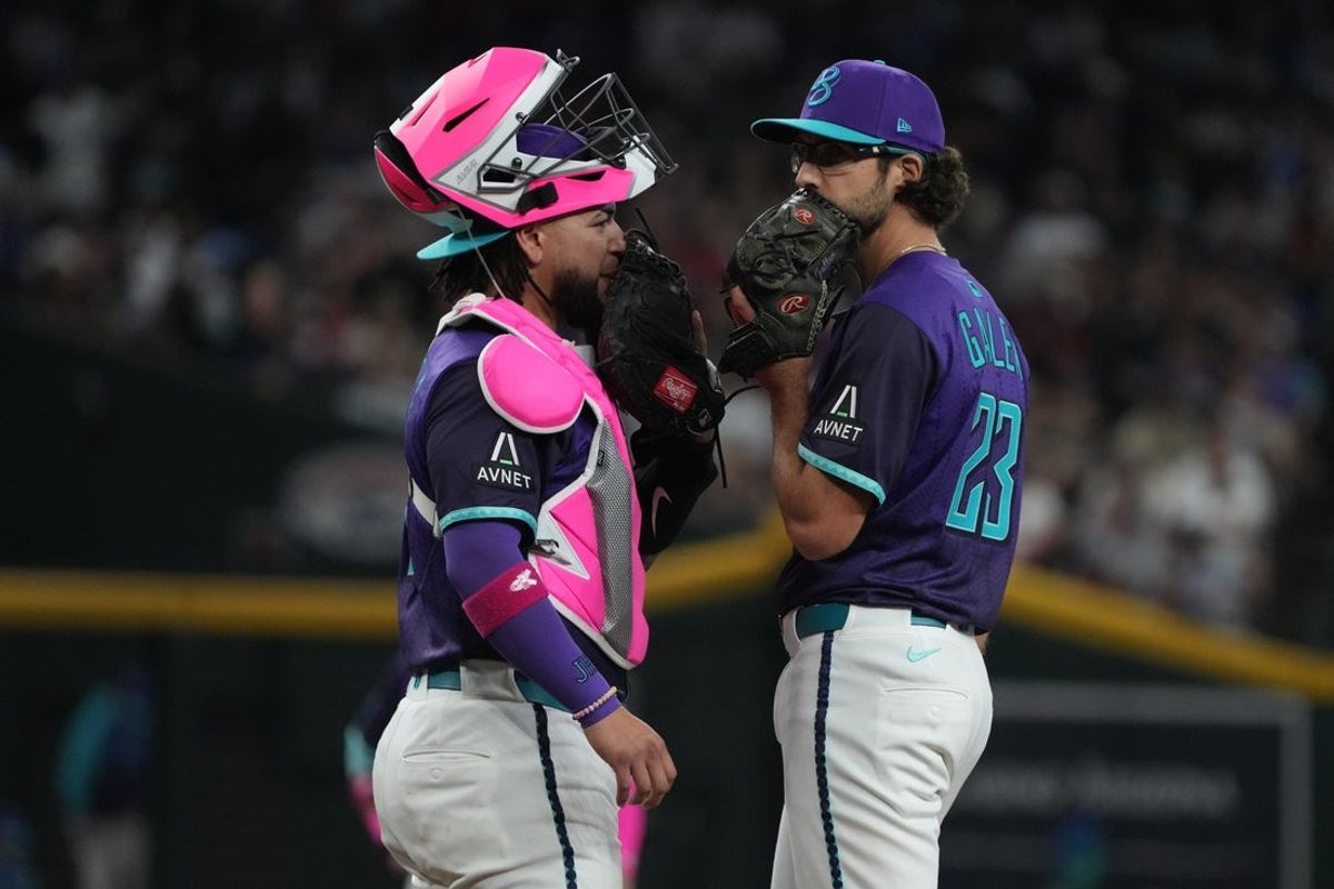 May 11, 2025; Phoenix, Arizona, USA; Arizona Diamondbacks catcher Jose Herrera (11) and pitcher Zac Gallen (23) talk in the fifth inning against the Los Angeles Dodgers at Chase Field. Mandatory Credit: Rick Scuteri-Imagn Images