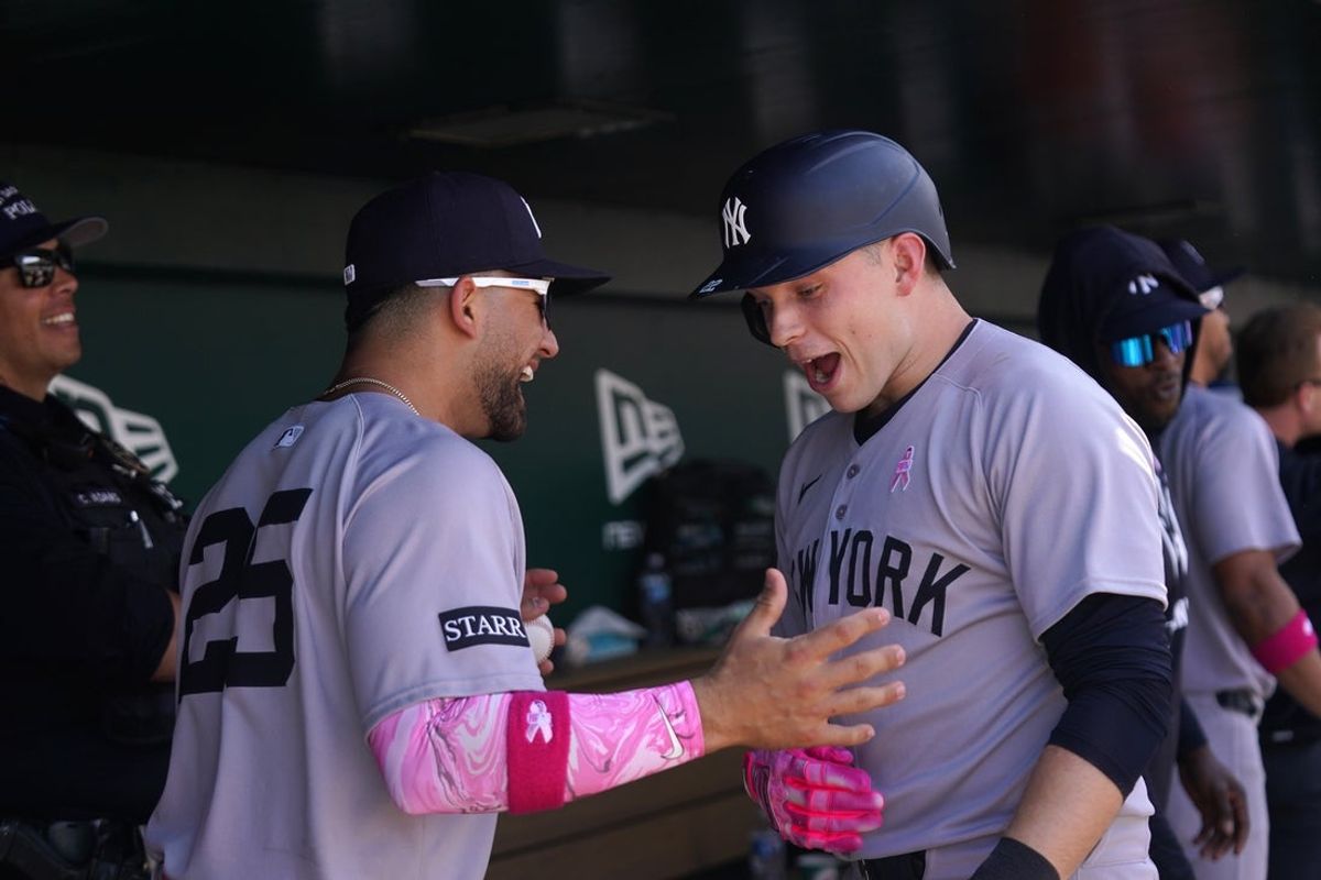 May 11, 2025; West Sacramento, California, USA; New York Yankees designated hitter Ben Rice (22) reacts next to catcher J.C. Escarra (25) after hitting a grand slam against the Athletics in the fifth inning at Sutter Health Park. Mandatory Credit: Cary Edmondson-Imagn Images